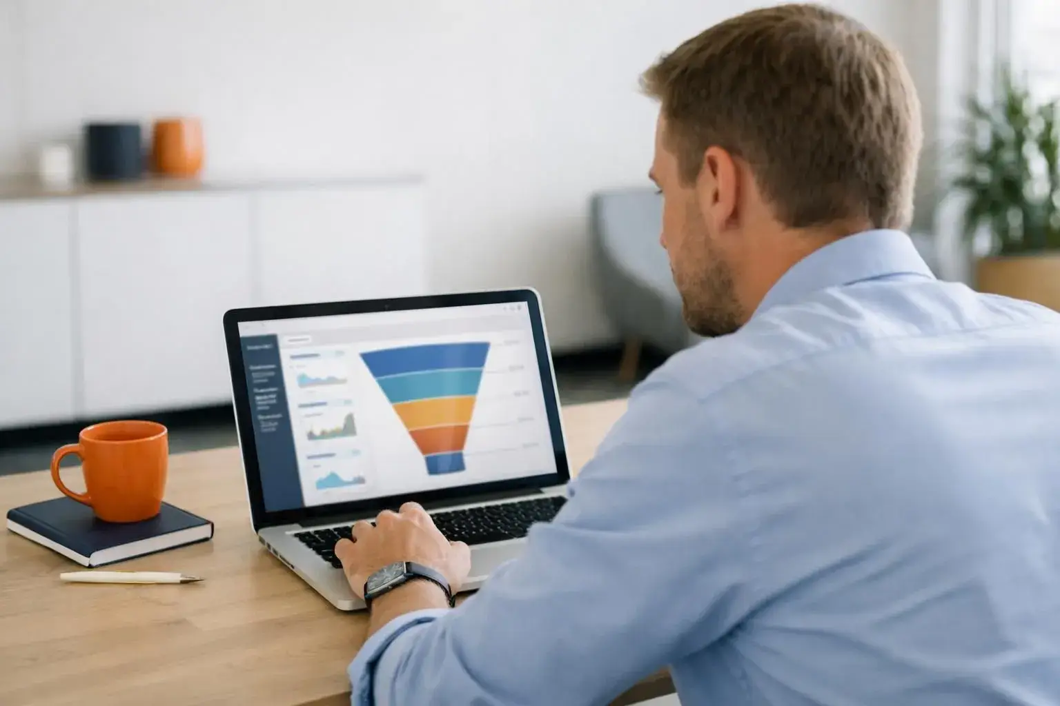 Professional marketing consultant analyzing lead qualification funnel on laptop screen with CRM dashboard visible, modern bright office setting, realistic business photography style